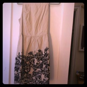 Tan dress with black flower design at the bottom